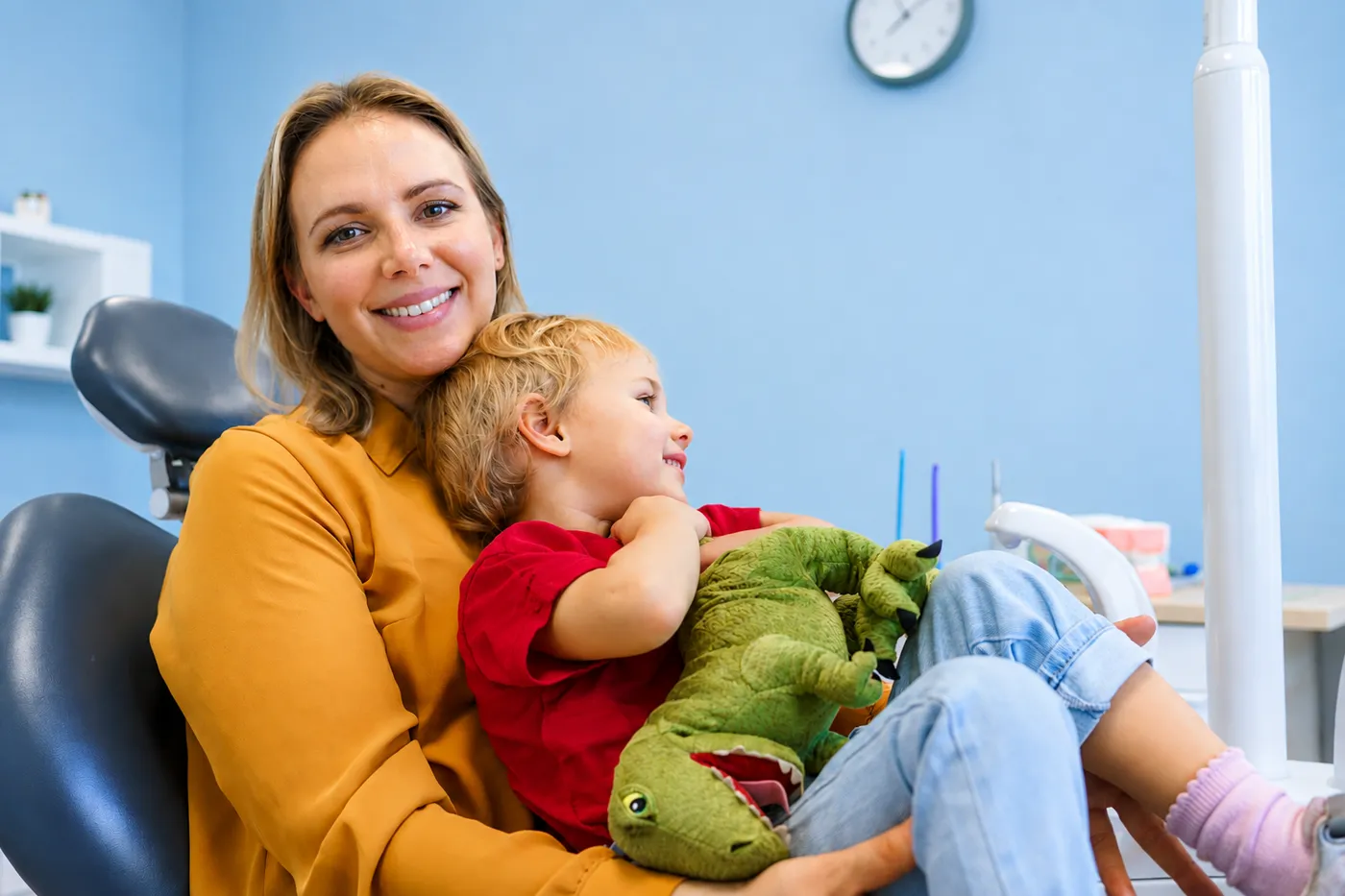 Parent comforting their child in the dental chair at Smiling Kidds